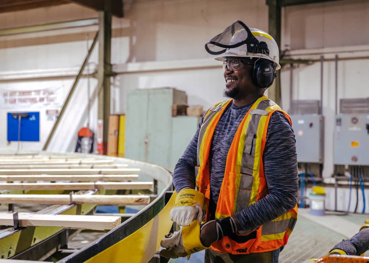 Smiling worker in prorective construction clothing